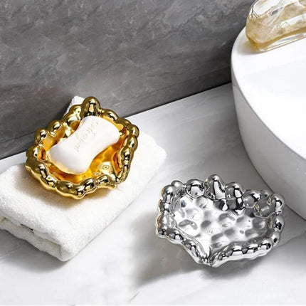 Guldfärgad lyxig tvålkopp i molndesign
